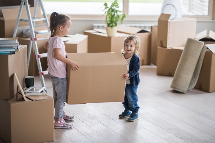 Children helping carring boxes during a house removal