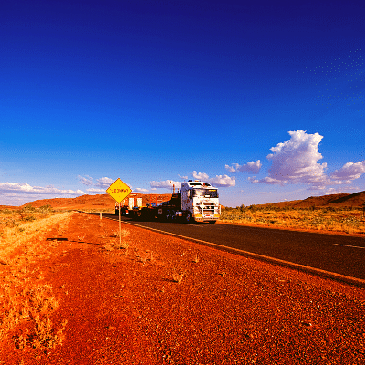 TRUCK ON ROAD TO WESTERN AUSTRALIA NORTH WESTERN AUSTRALIA FOR REMOVALS.  RED DIRT BLUE SKY